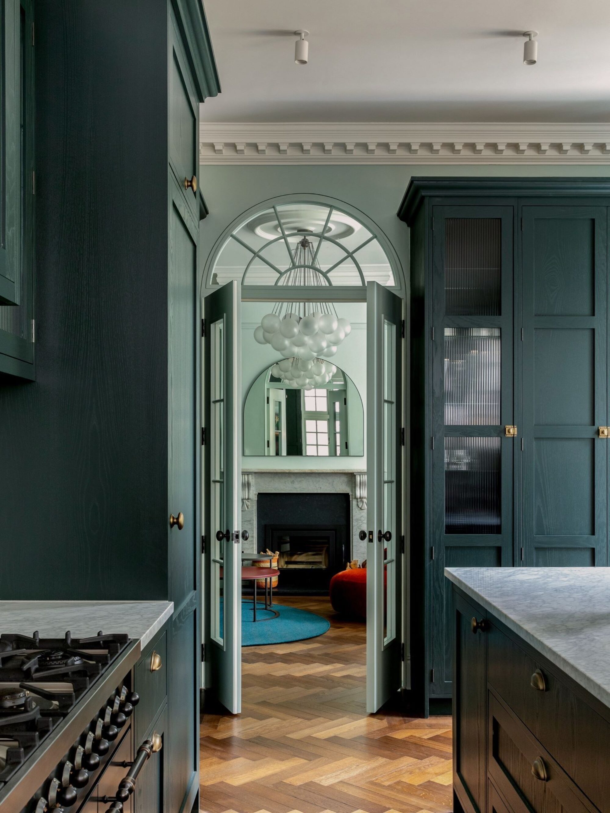 Dark brown Landmark Knole oak herringbone parquet in kitchen
