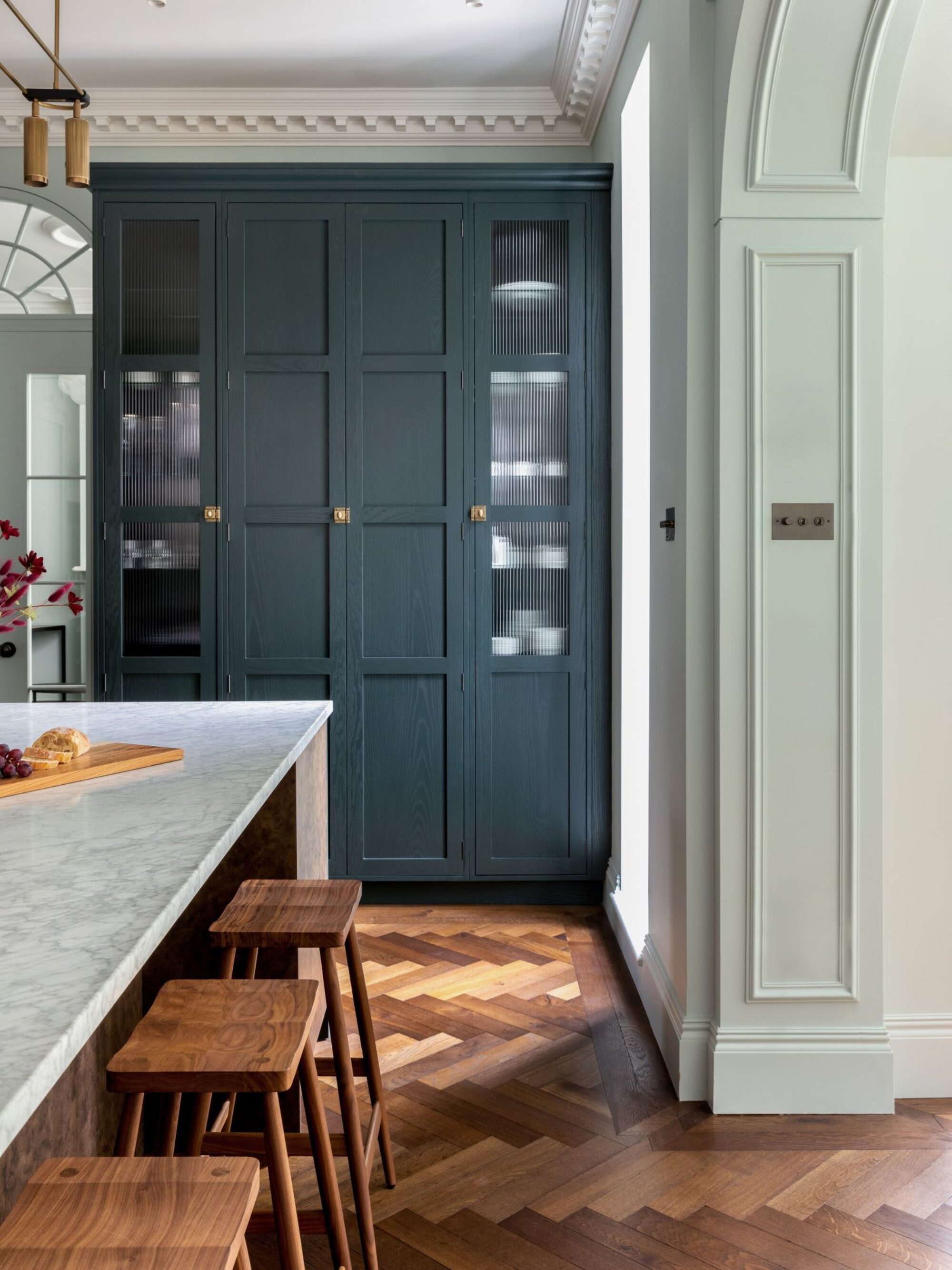 Dark brown Landmark Knole oak herringbone parquet with border in kitchen