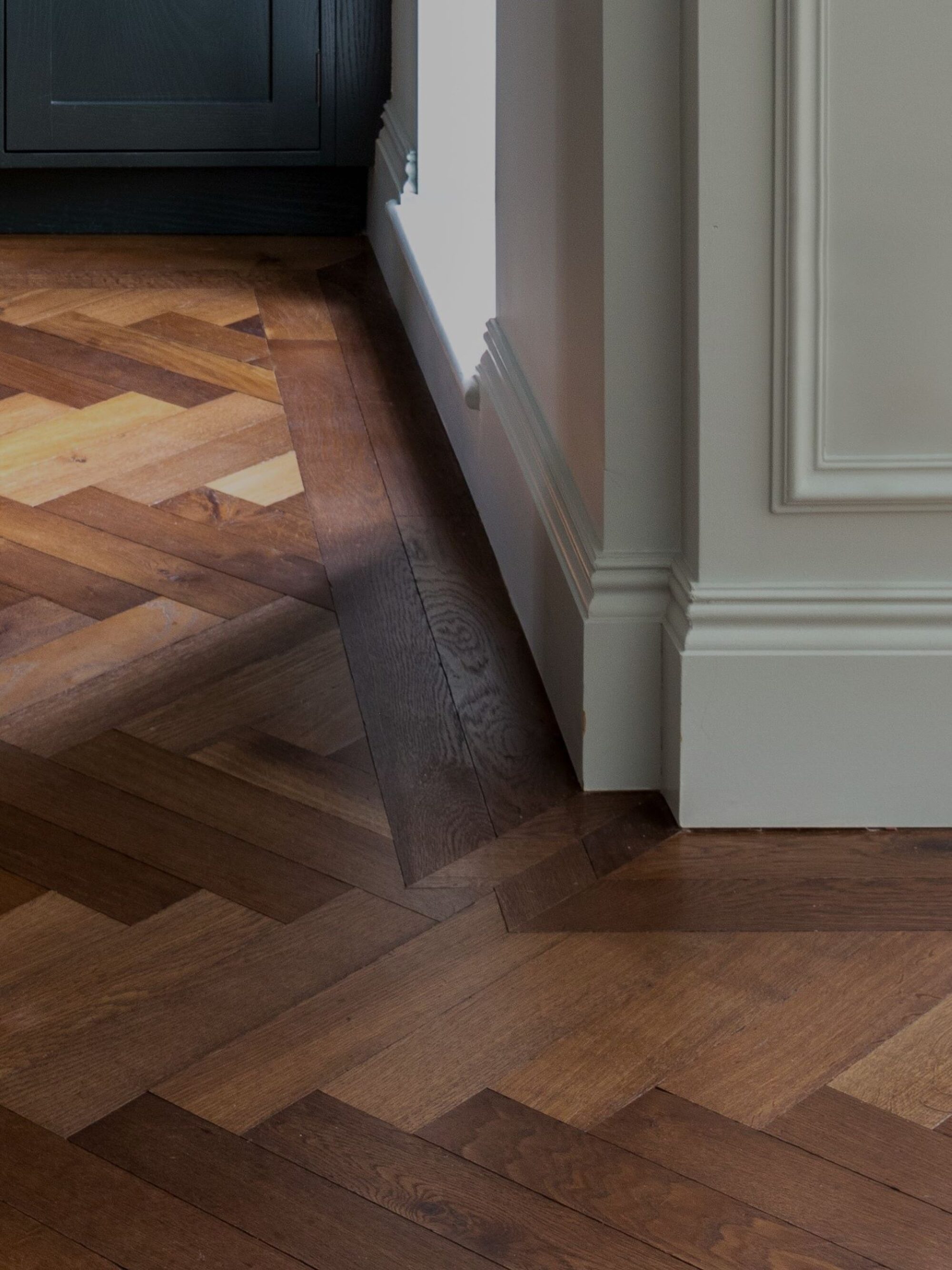 Detail of dark brown Landmark Knole oak herringbone parquet with double border