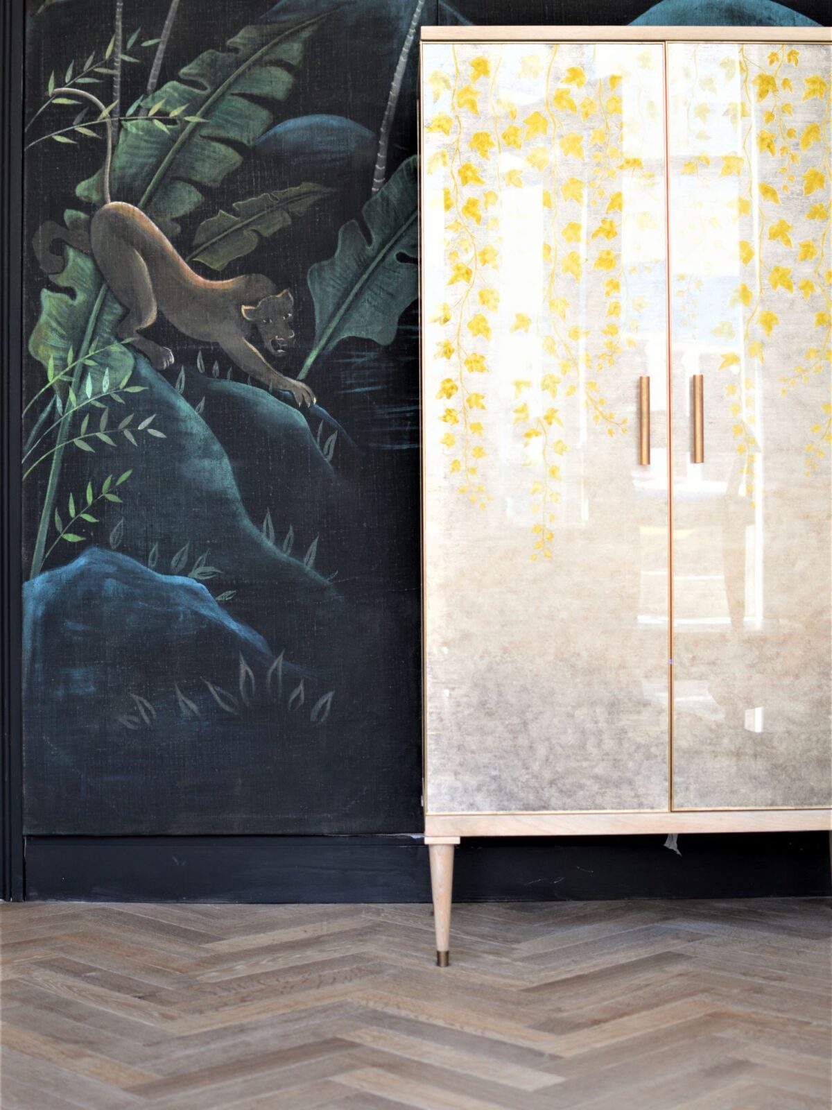 classic herringbone floor with mural & cabinet