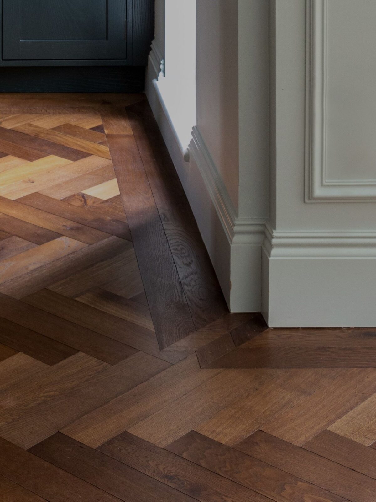 Detail of dark brown Landmark Knole oak herringbone parquet with double border