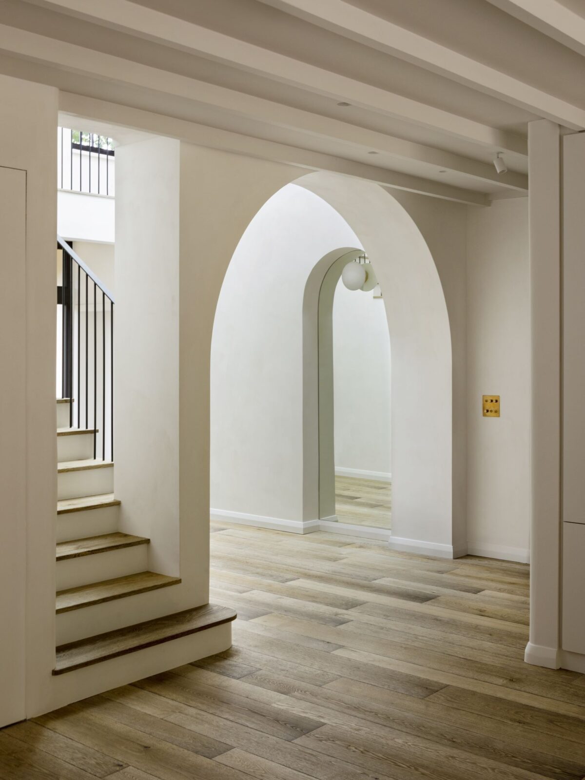 textured magma pacaya oak flooring in hallway with stairs on the left