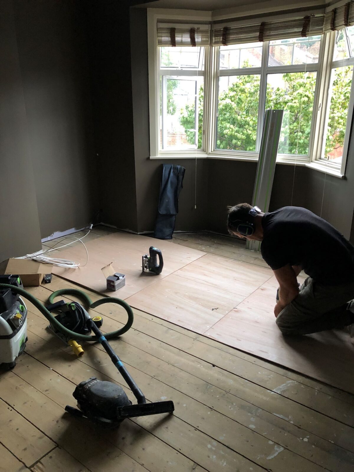 plywood screwed on top of old pine floorboards