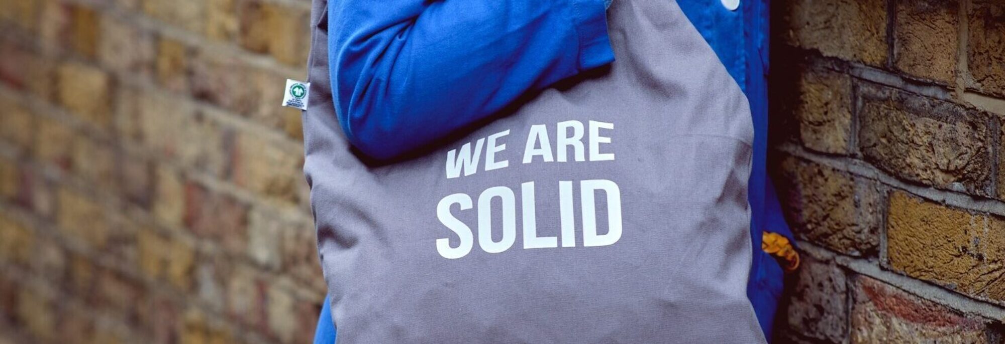 We are solid bag against brickwall