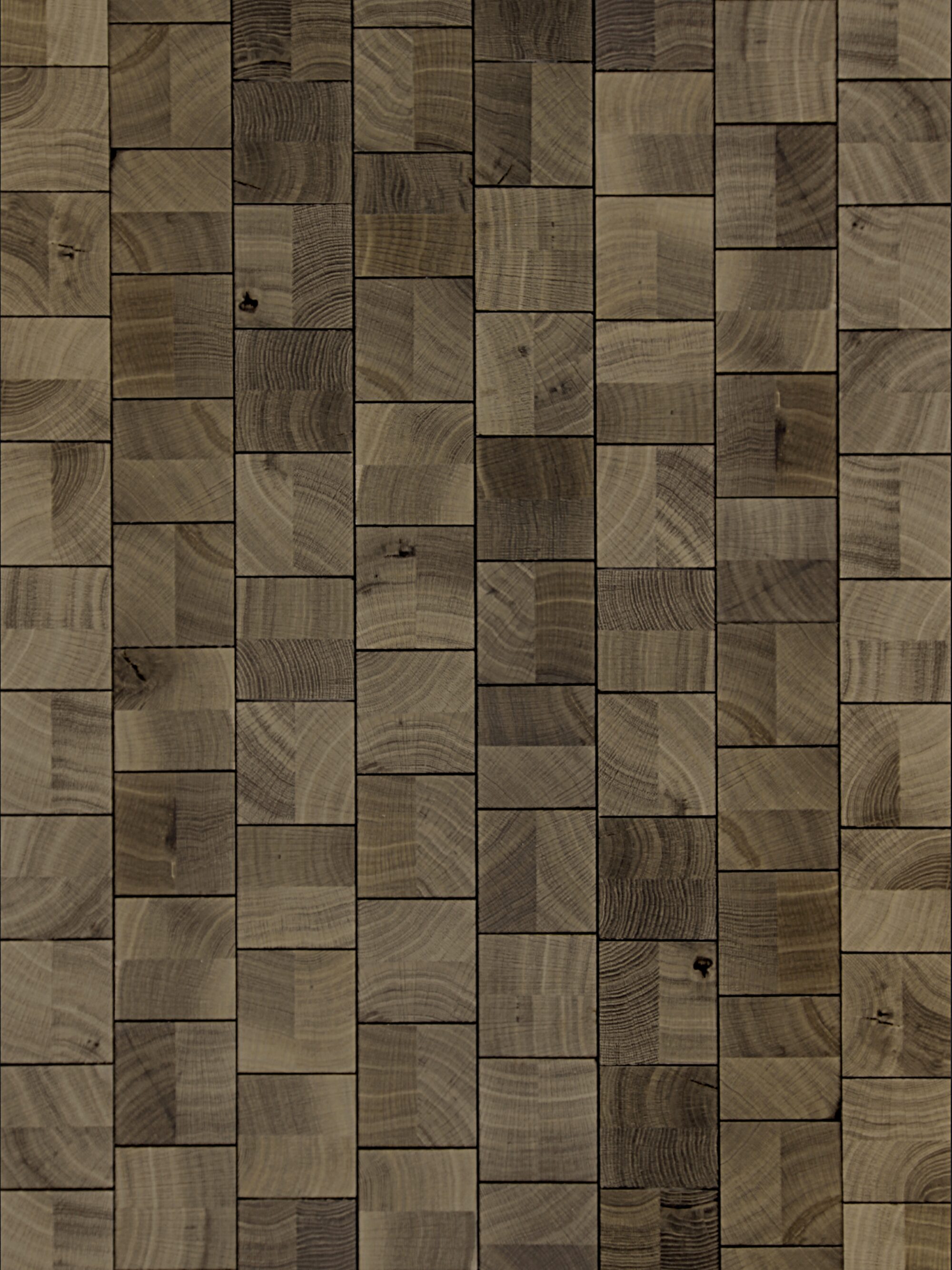Cube Smoke end-grain oak flooring by OscarOno: greyish-brown square blocks laid in staggered vertical rows, with growth rings, knots and tonal variation from block to block.