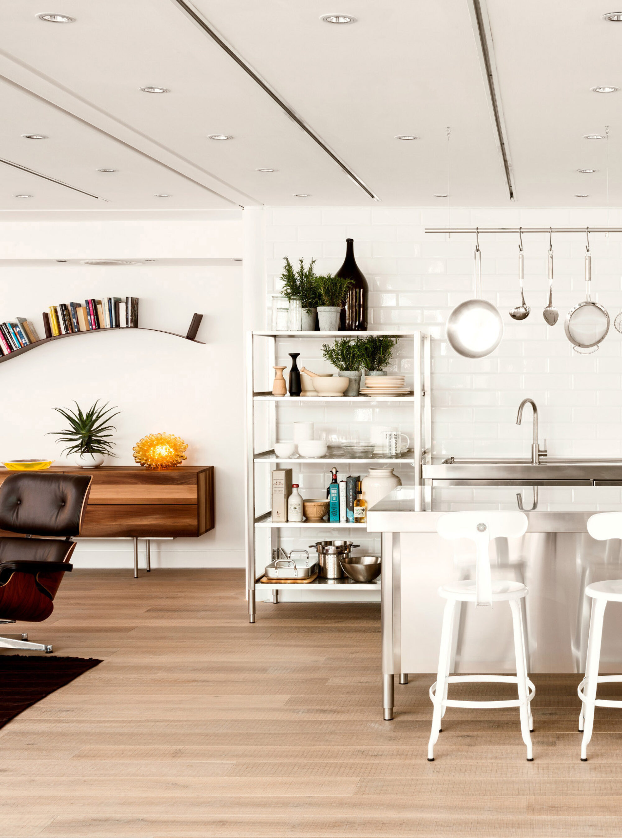 Oak tate skye plank in the conran store with open kitchen shelving and a eames lounge chair
