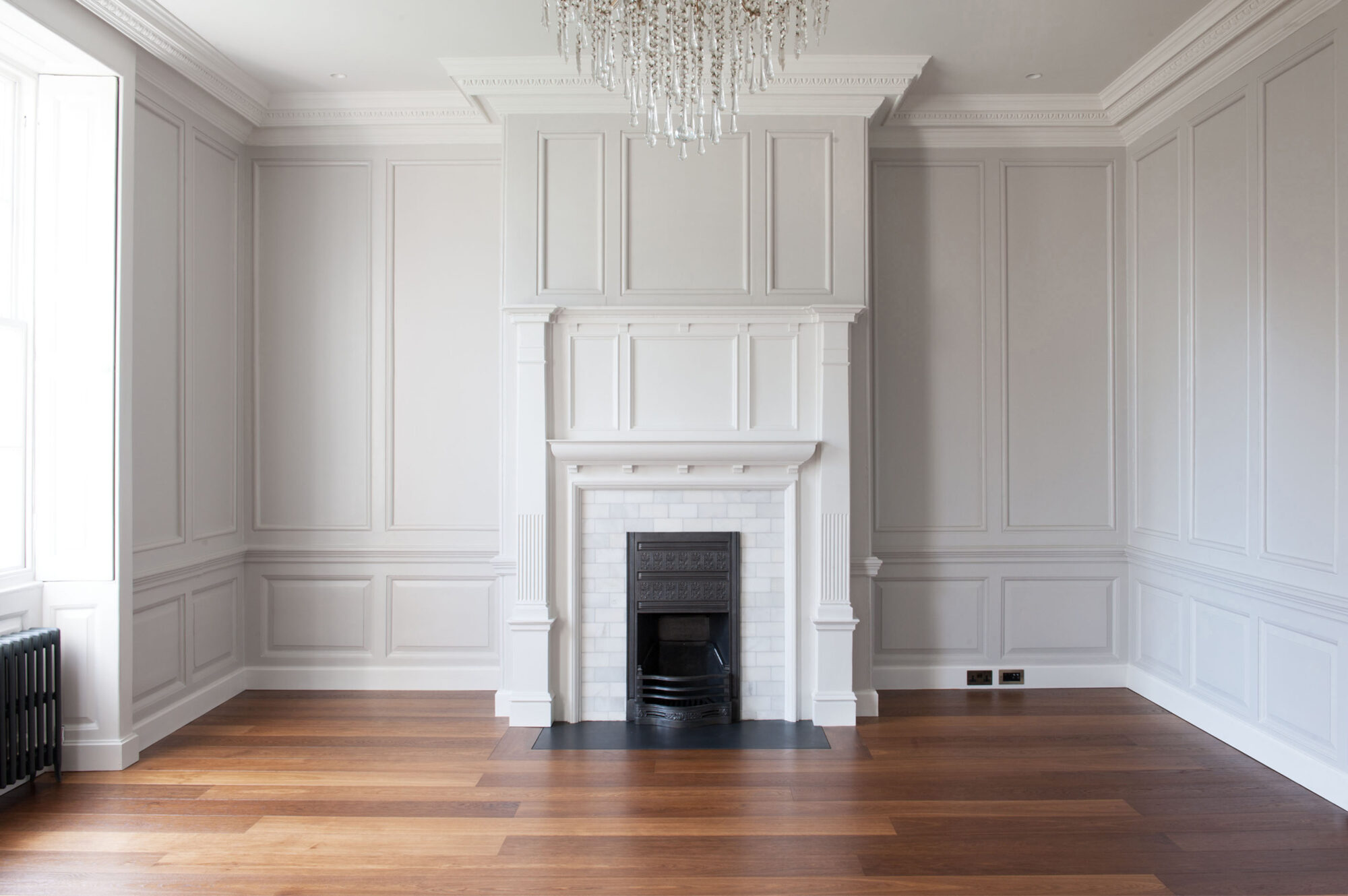 Oak landmark tatton planks in panelled room with marble fireplace and chandelier