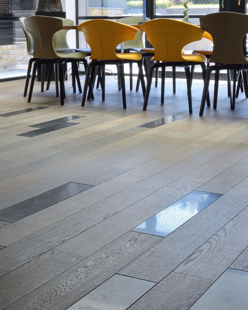 Oak tate tiree plank with inset floor tiles and a dining table and chairs