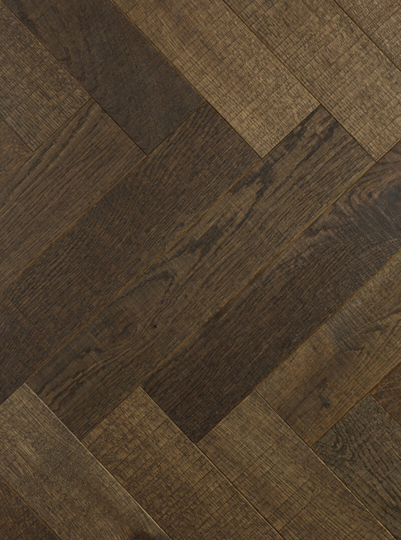 dark brown tate iona herringbone parquet oak flooring with black accents in the grain and the bandsaw marks