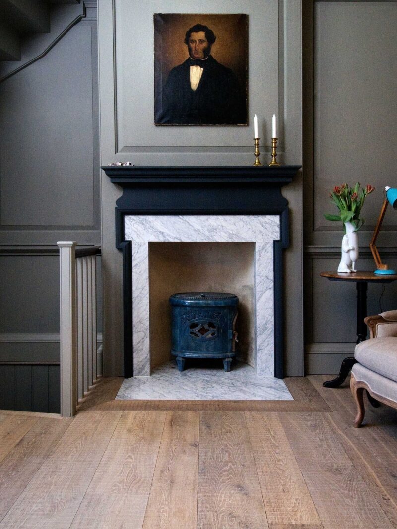 Interior with grey oak tate bute floor and grey panelling and marble fireplace with portrait