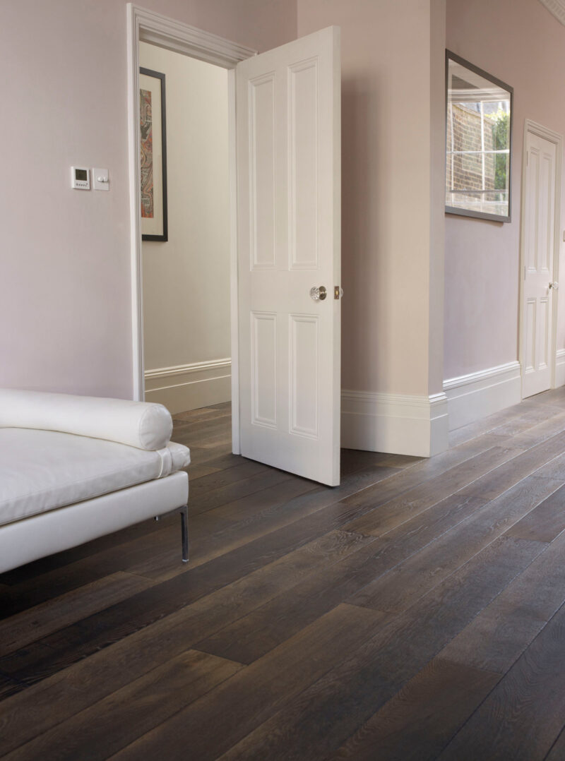 Oak landmark killerton plank dark brown floor with pink walls and white daybed