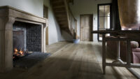 Magma Pacaya rustic floor in barn conversion with fireplace and curved staircase