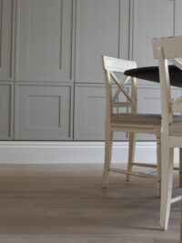 Oak tate bute flooring in dingroom with grey panelling