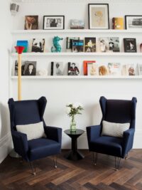 Oak landmark montacute herringbone floor in Library at the Laslett Hotel with blue chairs photo by Ana Cuba