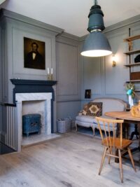 Tate bute flooring in almshouse with marble fireplace and grey paneling